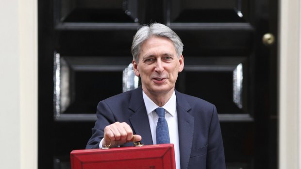 Chancellor of the Exchequer Philip Hammond holds the budget box.