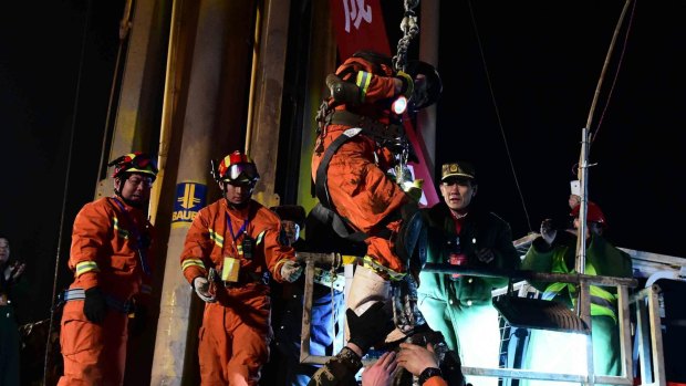 Emotional rescue ... Zhao Zhicheng, the first of four miners, is lifted from a collapsed mine by rescuers in Pingyi, east China's Shandong Province on Friday night. 