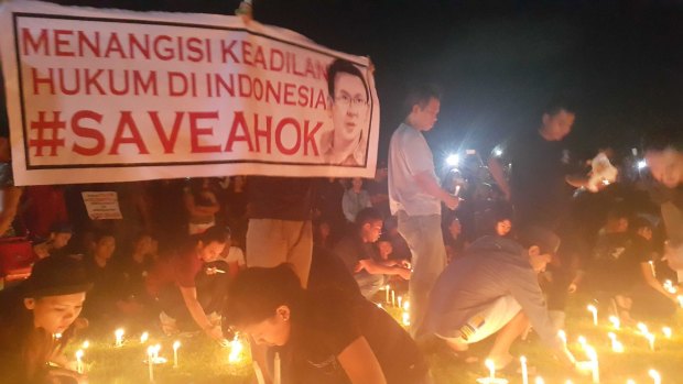 Supporters conduct a candlelit vigil in Bali in support of Ahok. The sign reads "Bitter over the lack of justice in Indonesian law".