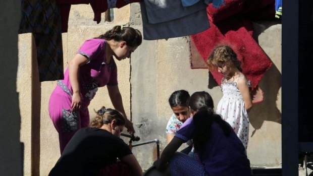 Displaced Iraqi women and children in the St Joseph church in the village of Ankawa, north of the Iraqi city of Erbil.