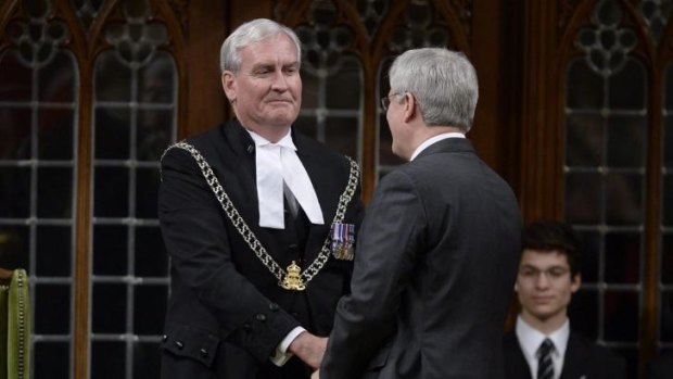 Prime Minister Harper shakes hands with  Sergeant-at-Arms Kevin Vickers in the House of Commons.