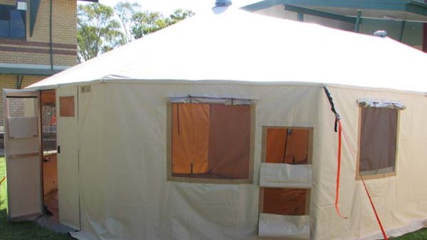 A fully-erected "flexible habitat" tent being deployed to the twice-revaged flood town of Condamine.