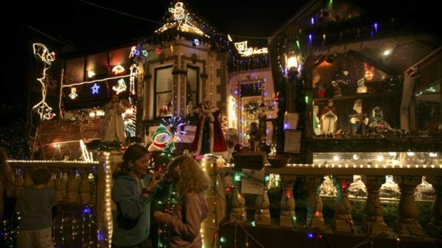 Deck the streets ... children enjoy the Christmas lights at a house on Frazer Street, Dulwich Hill. The owner, Michael Bonifacio, says he spends six weeks preparing the display.