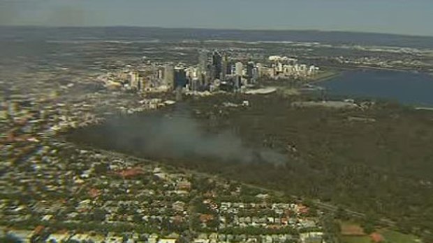 Smoke rises over Kings Park after a fire caught alight this afternoon.