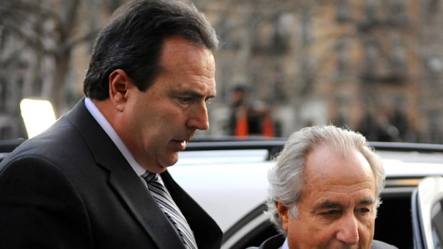 Guilty plea ... Bernard Madoff, right, arrives at Manhattan Federal court.