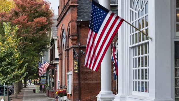 American flags fly on the quaint shops along Main Street of Stockbridge.