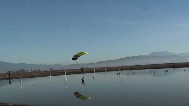 Reflected courage ... one of the contestants comes in across the water at Perris Valley.