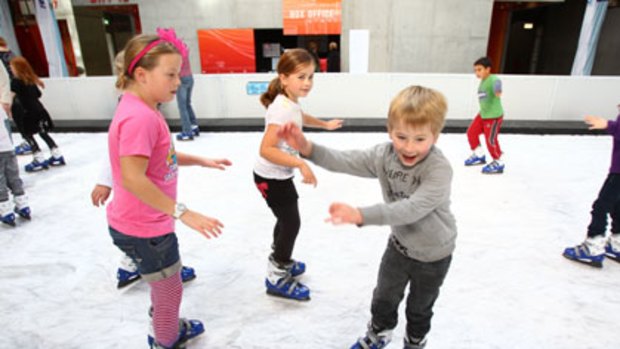 Shaky start ... children get the hang of it on the ice rink at Winterland at the CarriageWorks, Eveleigh.