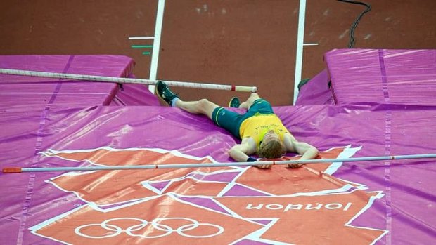 Steve Hooker lays on the matt after bombing out of the pole vault final without registering a height at the London Olympics.
