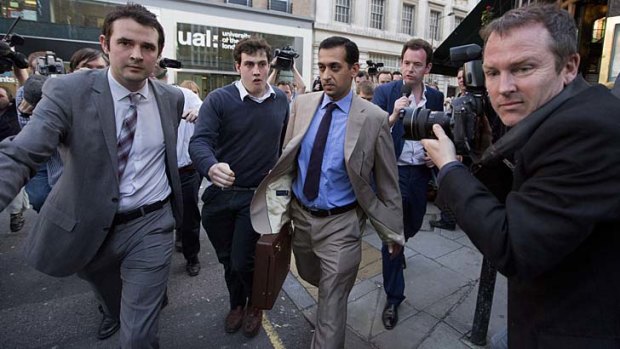 Mahmood Al Zarooni (centre) is followed by reporters as he leaves a disciplinary hearing at the British Horseracing Authority in central London on Thursday.