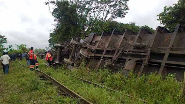 Rescuers observing the train known as "The Beast", after it derailed near Huimanguillo, in Tabasco State, Mexico.