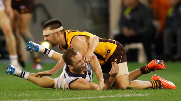 Luke Hodge gets close up and personal with Joel Selwood. 