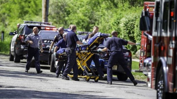 Rescue workers take a stabbing victim to an ambulance in Waukesha, Wisconsin.