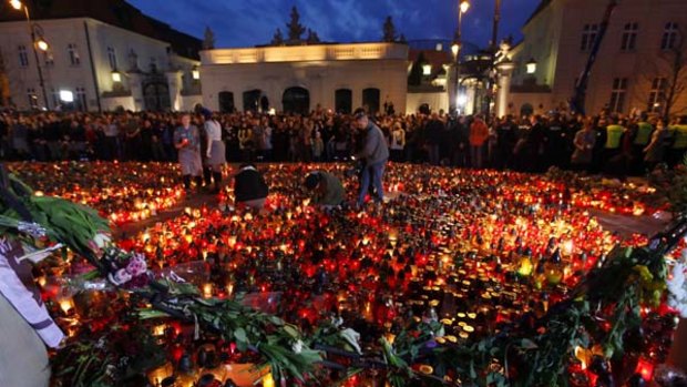 Paying their respects ... Poles light candles in front of the Presidential Palace in Warsaw.