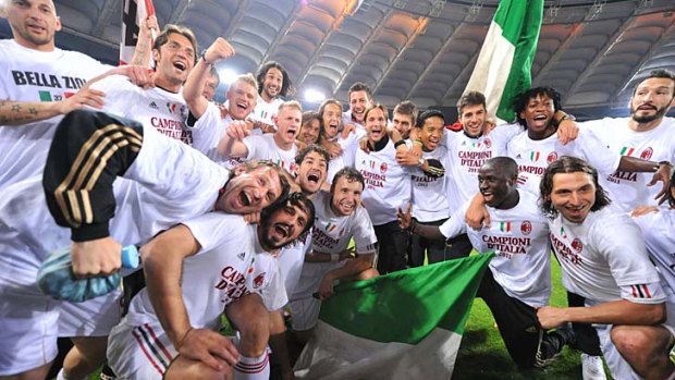 AC Milan players celebrate after drawing with AS Roma in May to claim the Serie A title.
