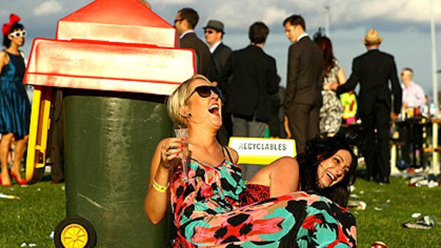 Two women fall about laughing as they enjoy the atmosphere at the Caulfield Guineas on Saturday.