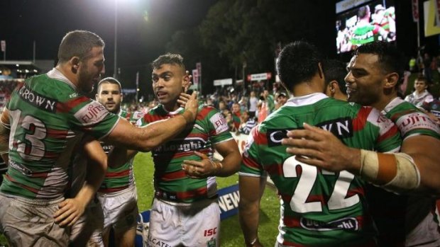 Merritt reward: South Sydney players congratulate Nathan Merritt after the winger scored his 145th try for the club, taking him past Benny Wearing's previous record.