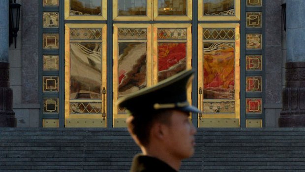 A Chinese para-military police standing guard beside the Great Hall of the People after the Communist Party Central Committee concluded its secretive Third Plenum in Beijing.
