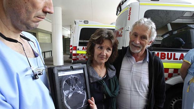 Making progress: Angela and Phillip Cramp, the parents of bashing victim Simon, with Dr Anthony Grabs, the head of trauma at St Vincent's Hospital.