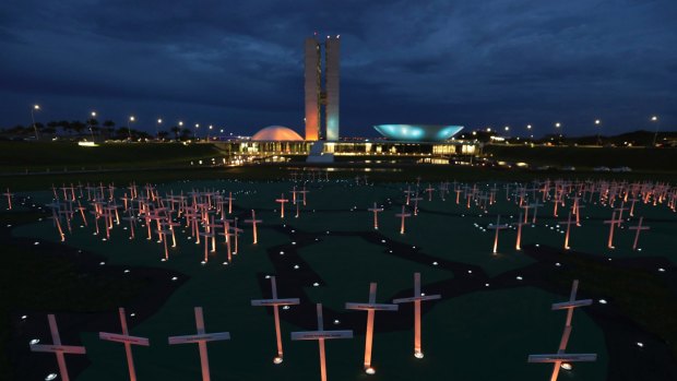Crosses depicting people murdered for defending the forest stand on a large map of the Amazon, during a protest against the illegal timber trade, in front of the Brazilian Congress last month.