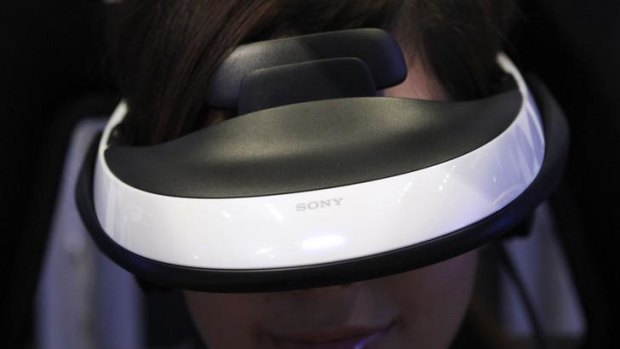 A model demonstrates using Sony's head mounted display "Personal 3D Viewer HMZ-T1" at its product launch in Tokyo.