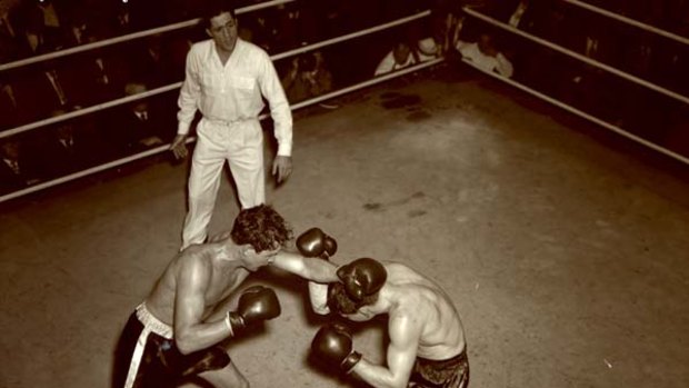 In the ring ... Burns (left) fights Pran Mikus at Sydney Stadium in 1953.