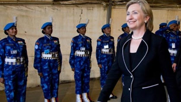 Forging contacts with women worldwide...Hillary Clinton reviews an honour guard of UN Indian police women near Monrovia in Liberia.