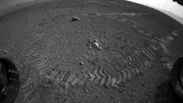 Track marks ... The rover made its first move, going forward about 15 feet.