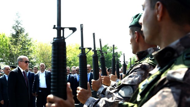 Turkish President Recep Tayyip Erdogan, in sunglasses, reviews police special forces at their headquarters in Ankara on Friday.