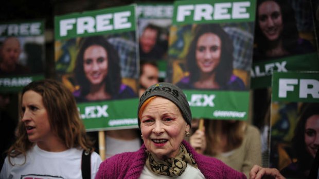 Vivienne Westwood stands in front of an Alex Harris poster as she takes part in a protest against the detainment of Greenpeace activists.