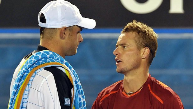 Lleyton Hewitt has a word with Andy Roddick after the American announced his withdrawal on Rod Laver Arena last night.