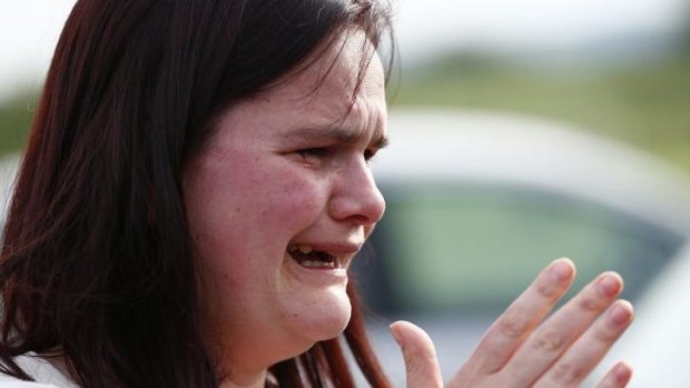 Former pupil Nichola Davies reacts outside Corpus Christi Catholic College after teacher Anne Maguire was fatally stabbed in Leeds, England.