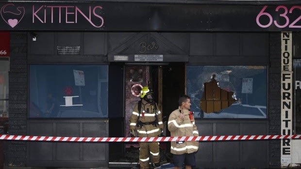 Firefighters outside the Kittens strip club in South Caulfield after it was bombed on Tuesday morning.