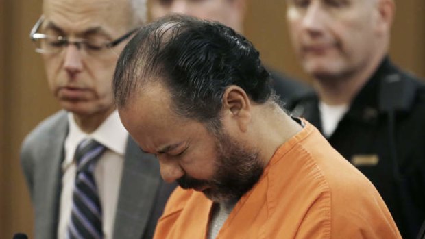 Facing reality: Ariel Castro stands, head bowed, as his lawyers enter a plea of not guilty. His first pre-trial hearing is scheduled for Wednesday.