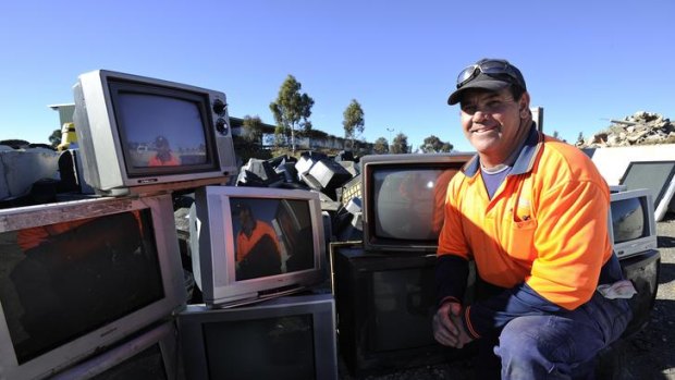 Mitchell Transfer Station's Doug Bailey with the old TVs that have been dropped off to be recycled.
