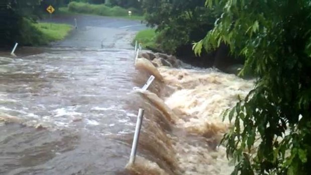 A torrent of water has flooded Cedar Creek Road, Cedar Creek, south of Brisbane.