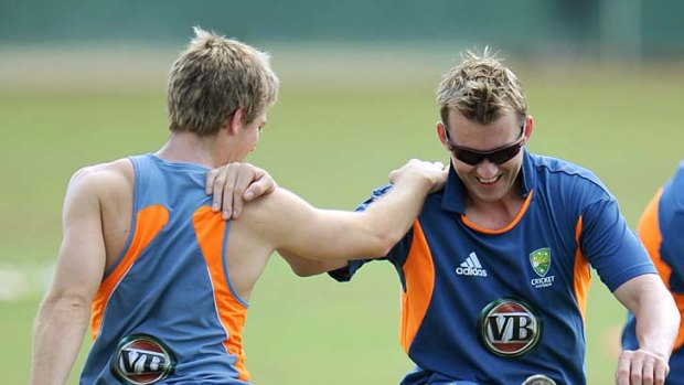 Stretching out: Brett Lee (right) with teammate Tim Paine ahead of training yesterday.