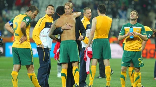 Mixed feelings ... Pim Verbeek hugs Tim Cahill after the match.