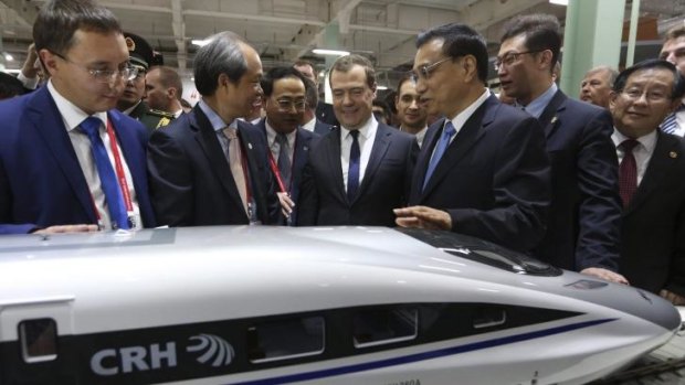 Russia's Prime Minister Dmitry Medvedev (fourth from right) and China's Premier Li Keqiang (third from right) visit an international forum and exhibition in Moscow. 