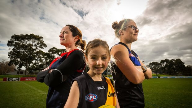 Catherine Nicholls, Molly Carr, 9, and Western Bulldogs player Emma Kearney at a footy clinic for women at Arden Street Oval.