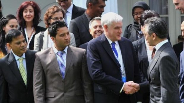 Critical of Australia's tow-back policy ... James Lynch (front, third from left), Regional Representative of the UNHCR for South East Asia Region shakes hands with Indonesian Foreign Minister Marty Natalegawa. 