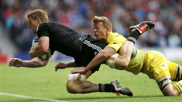 New Zealand's Bryce Heem beats the tackle of Australia's Cameron Clark to score during the men's Rugby Sevens semi-final at the Commonwealth Games in Glasgow.