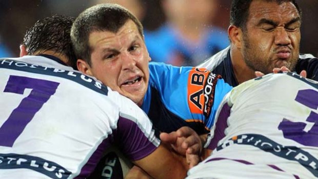 Greg Bird of the Titans runs into a wall of Storm defenders.