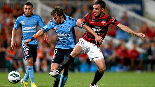 No quarter: Alessandro Del Piero of Sydney FC tangles with ex-Sydney man Mark Bridge in a derby last year.