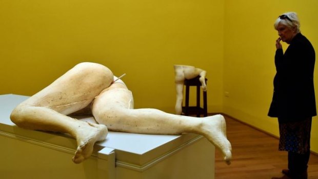 A visitor looks at a creation by British artist Sarah Lucas in the Great Britain pavilion.