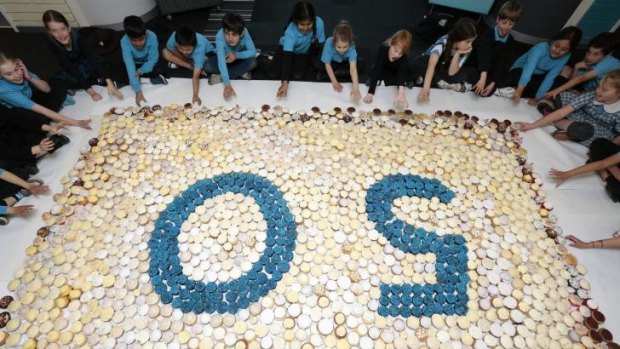 Sweet milestone: Hughes Primary School year 3 students tuck into over 1500 cup cakes that formed a 50 cupcake mosaic as part of the school's 50th birthday celebration.
