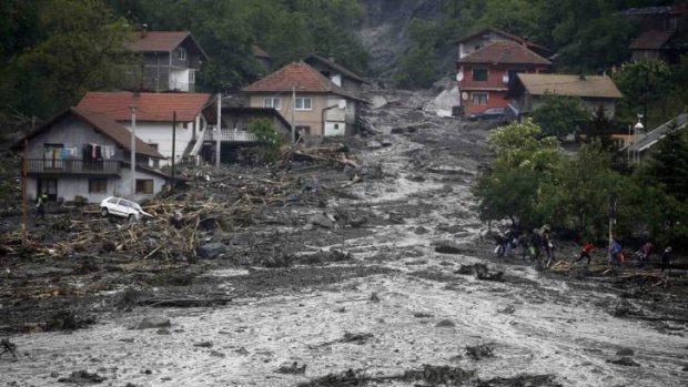 River of mud:  In the Bosnian village of Topcic Polje, a landslide   destroyed dozens of houses. Villagers fled on foot along railway tracks with bags and babies in their arms. 