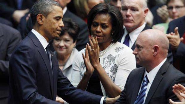 Barack and Michelle Obama with Gabrielle Giffords' husband, NASA shuttle commander Mark Kelly.