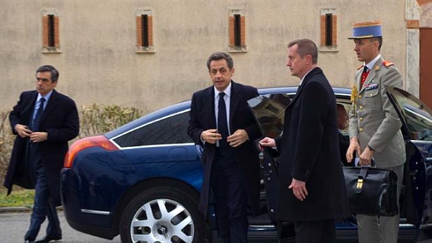 French President Nicolas Sarkozy arrives in Toulouse as police and response teams surround a property nearby.