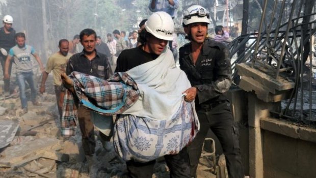 Rescuers carry a body following a reported "barrel bomb" attack by Syrian government forces in the northern city of Aleppo. Reports suggest that some barrel bombs contain household chemicals.